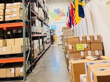Valutek's warehouse: Pallet racking and shelves are displayed on the left; customer orders prepared for shipping are situated on the right side.